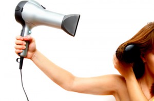 female hand holding hairdryer growing out hair