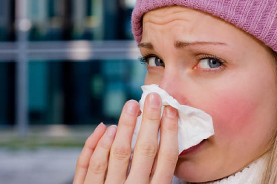 woman blowing nose