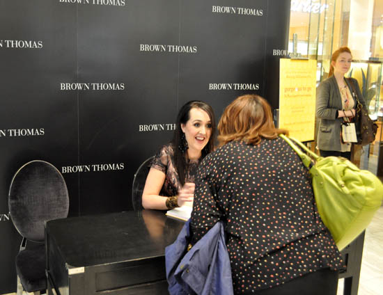 Aisling signing a book
