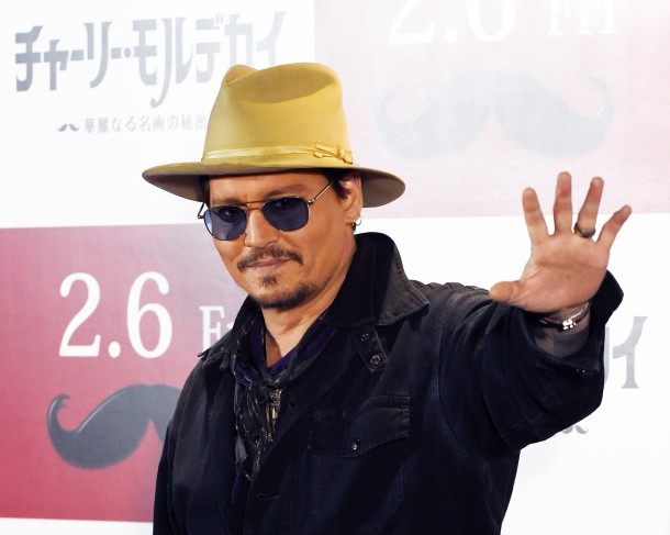 US actor Johnny Depp waves during his photo call in Tokyo on January 28 2015.  Depp attended the Japan premiere of his latest action comedy movie "Mortdecai" on January 27 which will be screened in Japan from February 6.    AFP PHOTO / TOSHIFUMI KITAMURA        (Photo credit should read TOSHIFUMI KITAMURA/AFP/Getty Images)