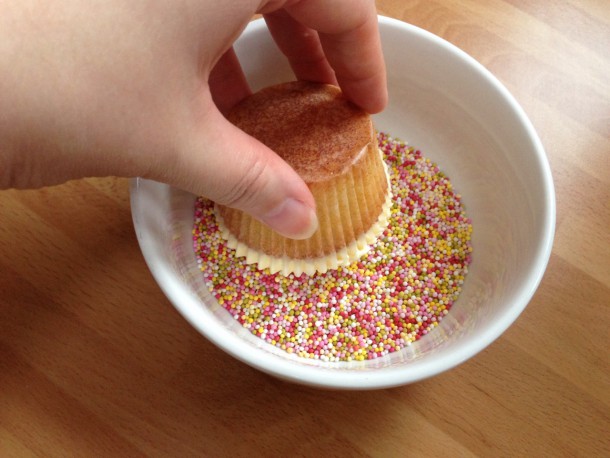 14. Dipping the cupckae into sprinkles