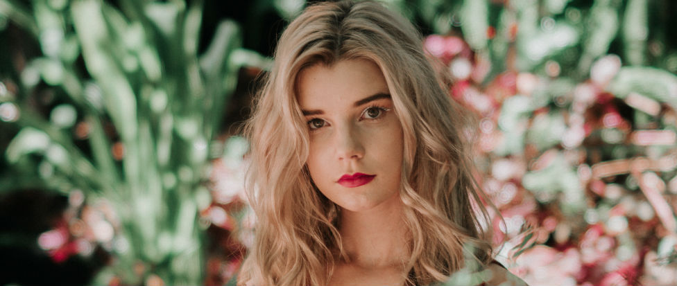 blonde woman in garden wearing red lipstick