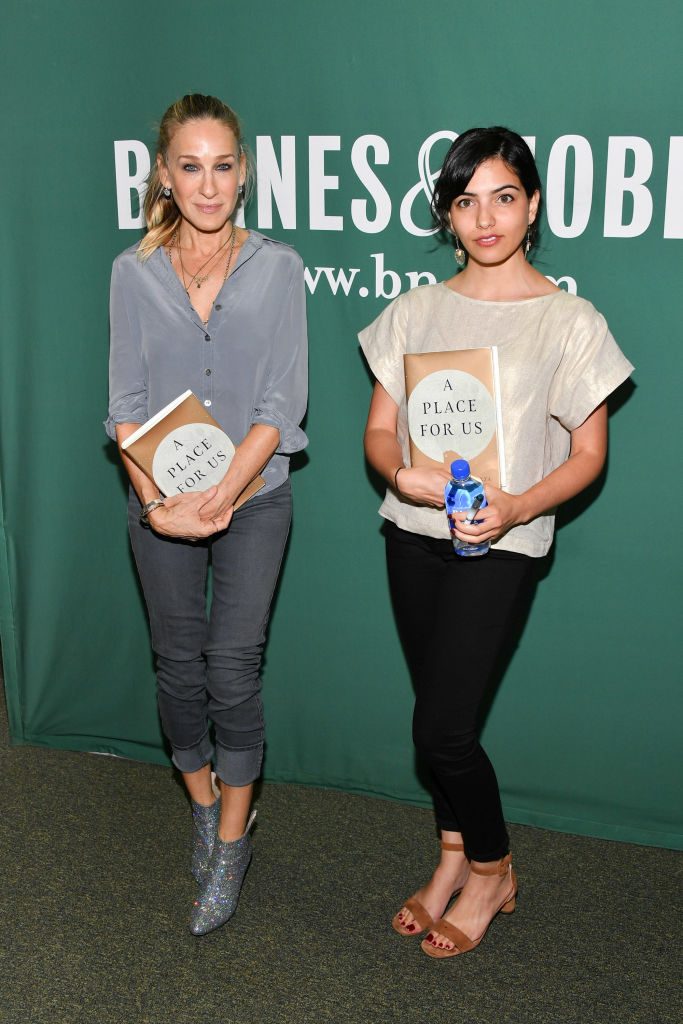 Sarah Jessica Parker (L) and Fatima Farheen Mirza attend Fatima Farheen Mirza in conversation with Sarah Jessica Parker holding copies of novel A Place for Us