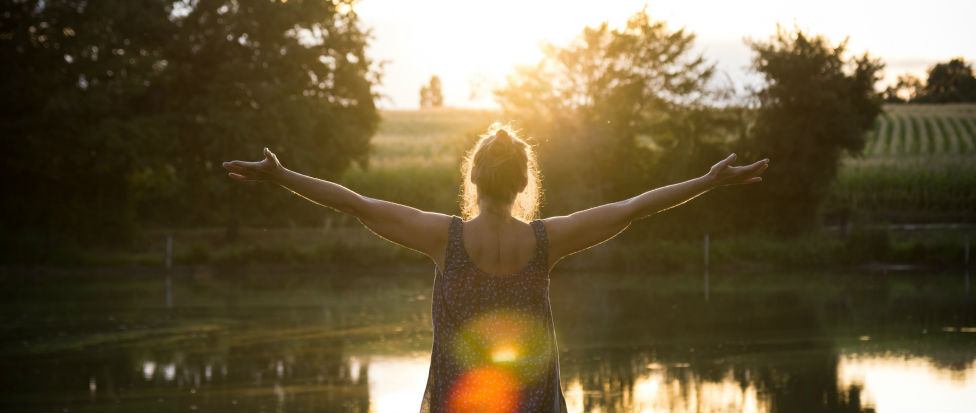 woman wide arms sunset