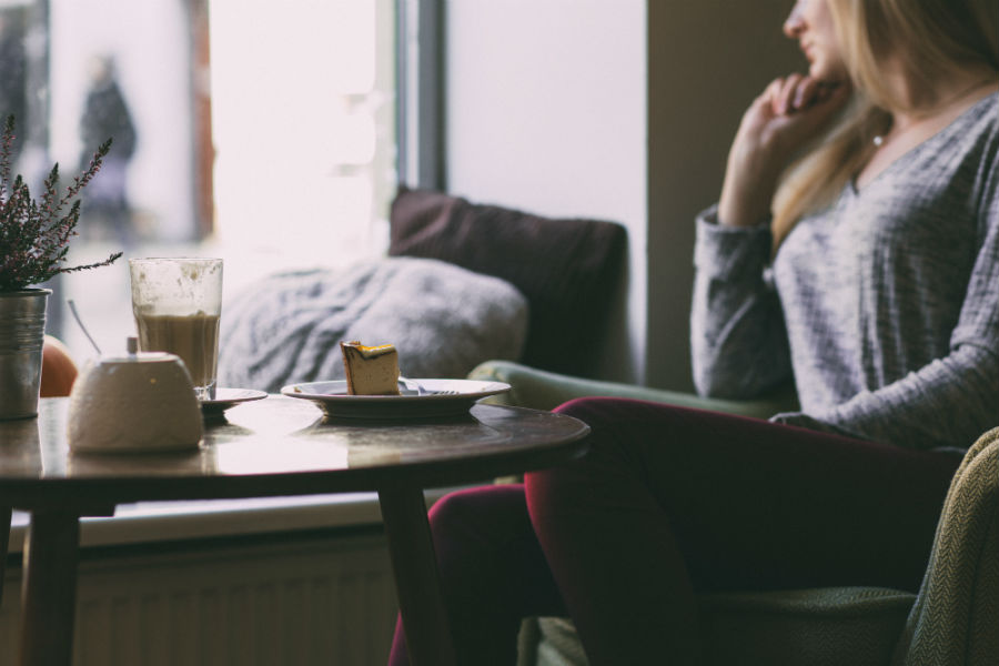 women sitting turned away from cake and tea tableaux