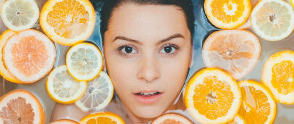 woman in bath with oranges