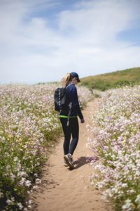 Girl walking through a field